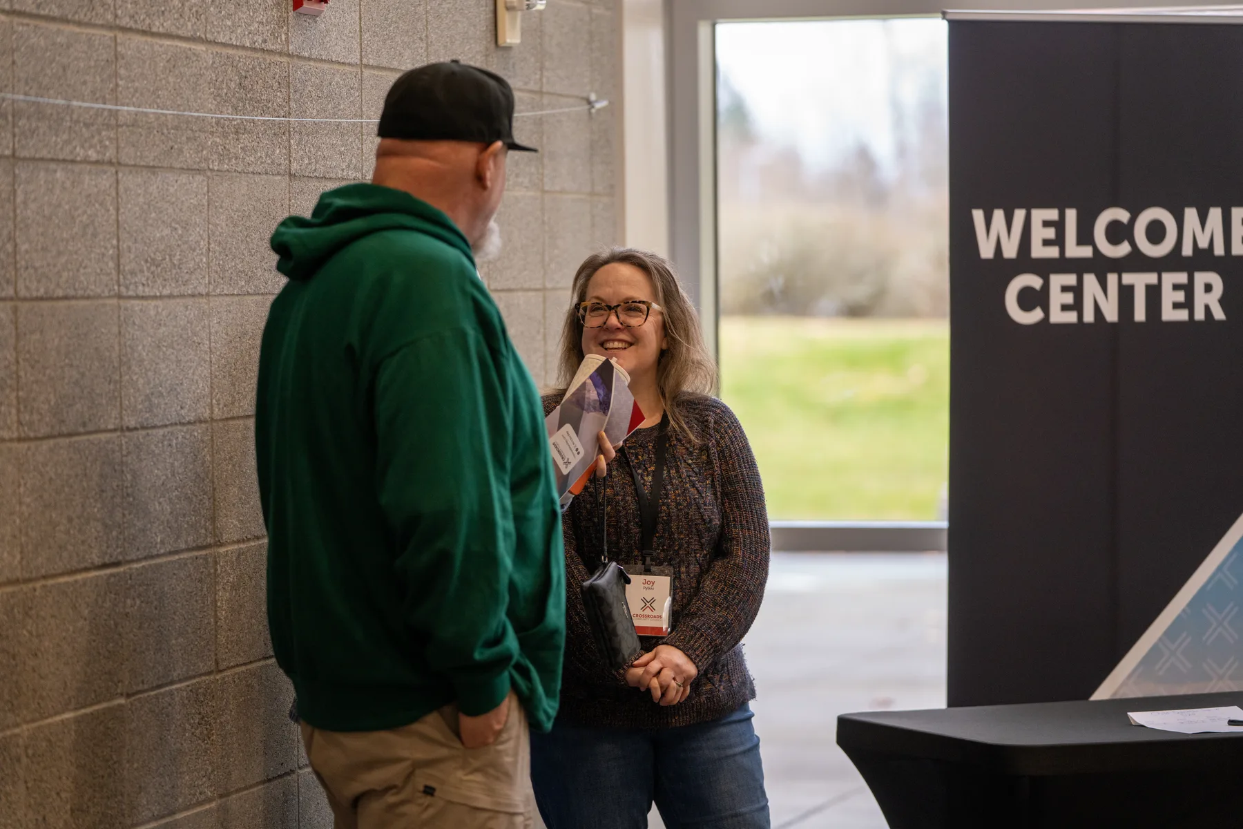 Crossroads Welcome Center volunteer connecting with a guest
